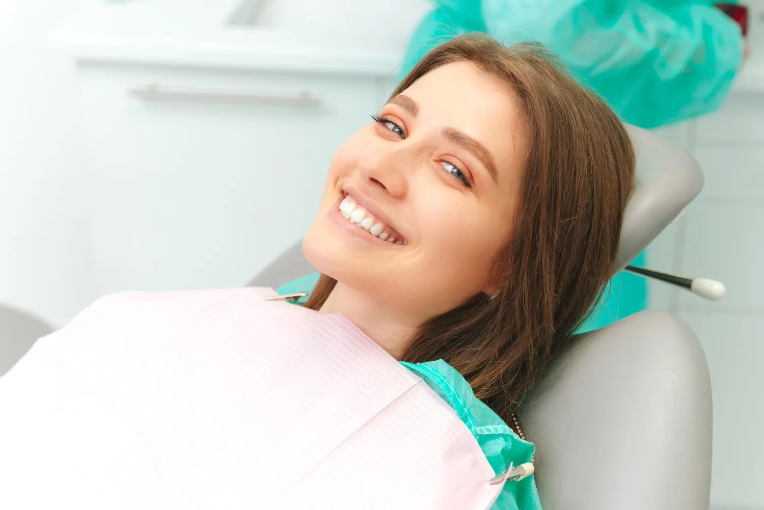 Smiling lady lying on dental chair - Lakeway Cosmetic and Family Dentistry